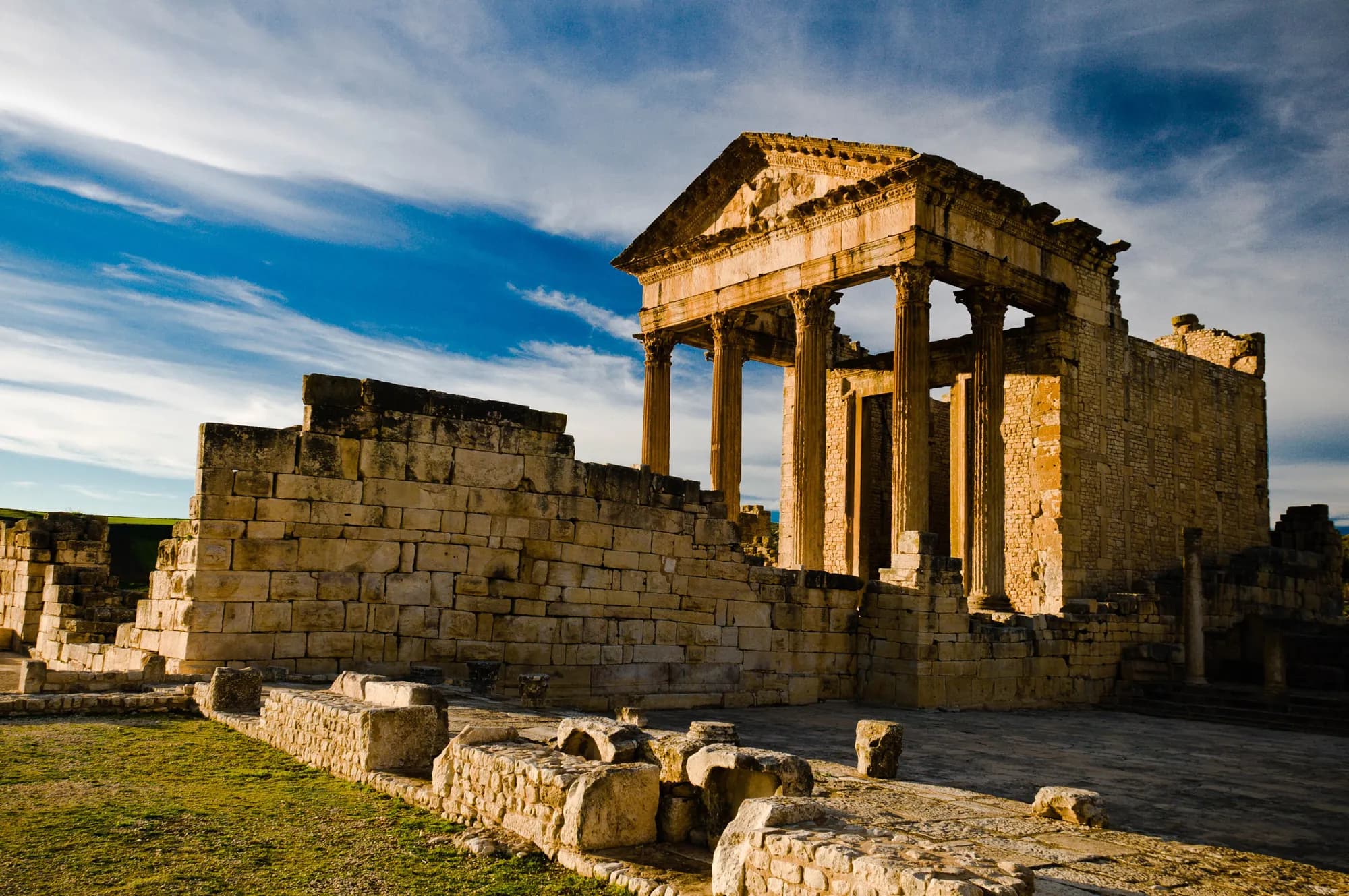 The Capitol of Dougga under a cloudy sky